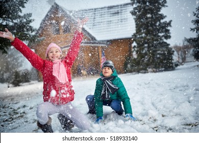 Children Playing With Snow And Having Fun Outdoor
