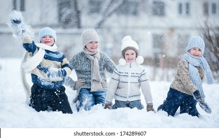 Children Playing In The Snow On A Winter Day