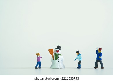 children playing in snow with snowman isolated on white background - Shutterstock ID 2211538753
