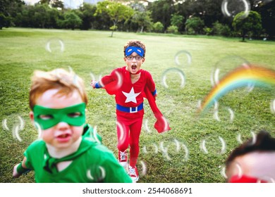 Children playing superheroes in a park. Boys in superhero costumes, one in red and one in green. Happy children enjoying outdoor play, dressing as superhero and having fun in a park. - Powered by Shutterstock