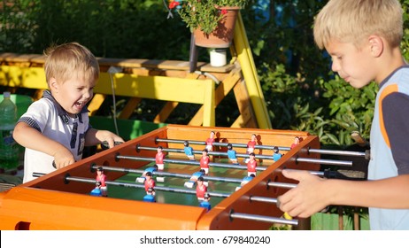 children playing table football outdoors.Fun outdoors - Powered by Shutterstock