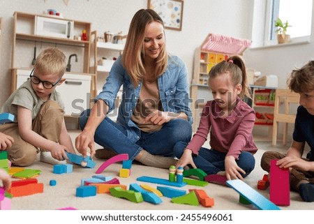 Children playing with toy blocks in the kindergarten