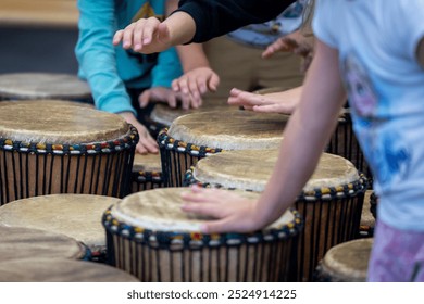 Children Playing Traditional African Drums in Group Music Activity - Powered by Shutterstock