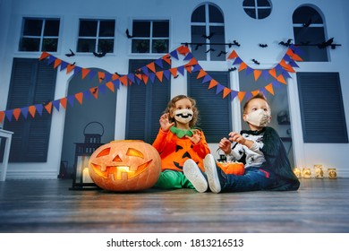 Children are playing trick or treat in halloween costumes and face masks at a festival. - Powered by Shutterstock