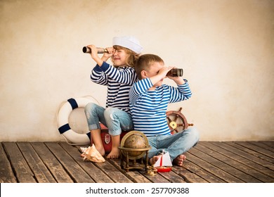 Children Playing With Vintage Nautical Things. Kids Having Fun At Home. Travel And Adventure Concept. Retro Toned Image