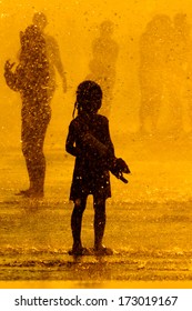 children playing in water silhouette / water gun / water war