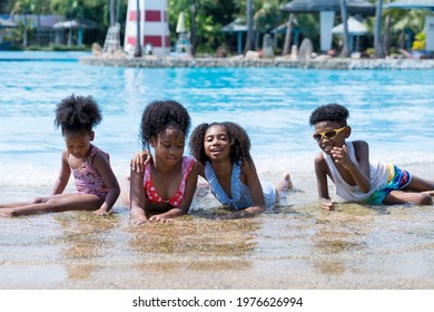 Children Playing In The Water Theme Park. Children In Holiday.