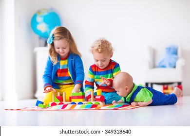 Children Playing With Wooden Train. Toddler Kid And Baby Play With Blocks, Trains And Cars. Educational Toys For Preschool And Kindergarten Child. Boy And Girl Build Toy Railroad At Home Or Daycare.