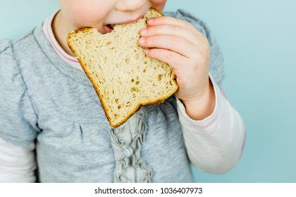 Children With Poor Nutrition. Kid Eating White Bread. Child With Bad Eating Habits.