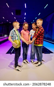 Children Poses On The Lane In Bowling Alley