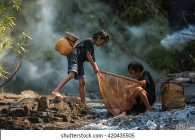 Children poverty living in countryside Vietnam are fishing at the river.