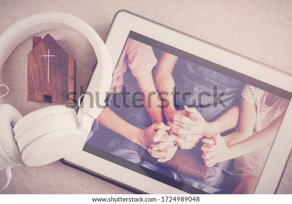 Children praying\
with father parent with  digital tablet, family and kids worship\
online together at home, streaming online church service, social\
distancing, new normal\
concept