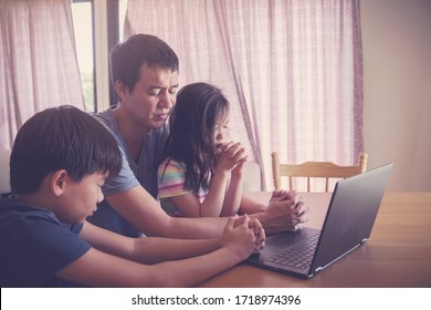 Children Praying With Father Parent With Laptop, Family And Kids Worship Online Together From Home, Streaming Online Church Service, Social Distancing, New Normal Concept