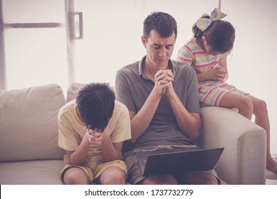 Children praying with father parent with laptop, family and kids worship online together at home, streaming church service, social distancing concept