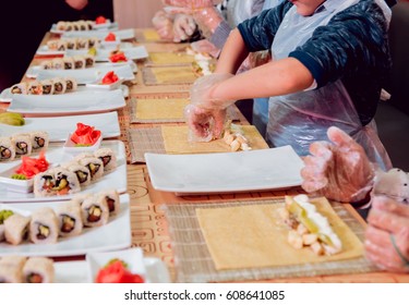 Children prepare sushi and rolls. Master-class restaurant.