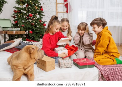 Children preteen opening magic Christmas gift at home. Boxing Day. - Powered by Shutterstock