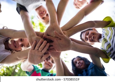 Children Putting Their Hands Together In Park