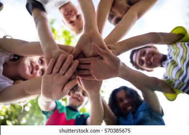 Children Putting Their Hands Together In Park