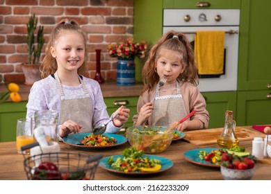 Children In Pyjamas Making Pancakes In Kitchen At Home Following Recipe On Digital Tablet - Powered by Shutterstock