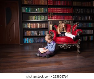 Children Reading Book At Home. Boy And Girl In Library