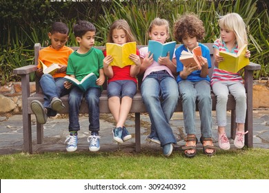 Children Reading From Books Together While Sitting Down