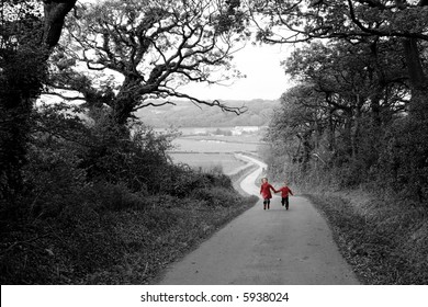 Children In Red Coats Running Up Farm Road