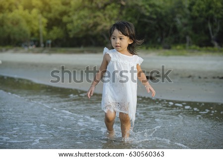 children relax on the beach,Happy young children  at  sunshining  beach in Thailand. 
