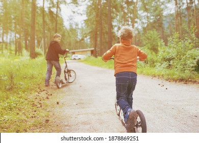 Children Ride On The Push Scooter