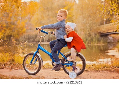 Children Riding Balance Bike. Kids On Bicycle In Sunny Park. Little Girl And Boy Ride Glider Bike On Bright Autumn Fall Day. Preschooler Learning To Balance On Bicyclet. Sport For Kids.