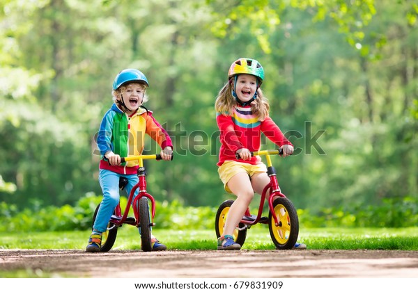 kids riding balance bikes