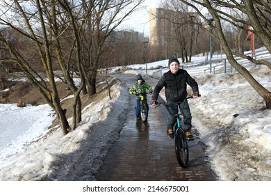 Children Riding Bikes On Sidewalk In Spring