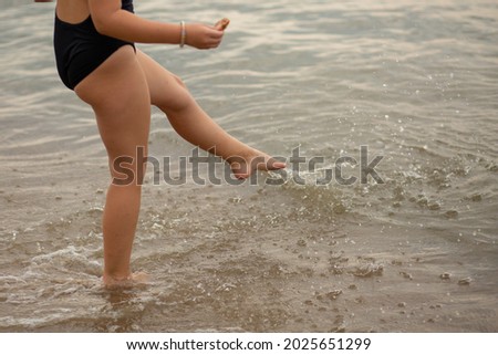 children run along the beach, near the sea, beautiful sunset, children's feet