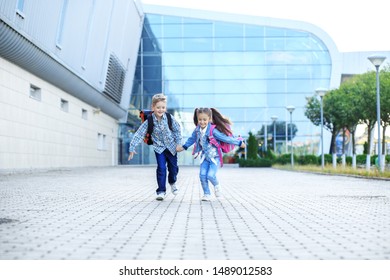 Children Run With Backpacks. Little Boy And Girl. The Concept Is Back To School, Study, Friendship And Family.