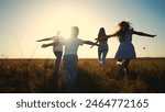 The children run play in forest. happy family kid dream concept. The children running in the park silhouettes. children kid running across the field group in park silhouette at lifestyle sunset