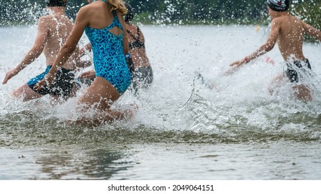 Children Running Into A Lake During A Kids Triathlon Competition