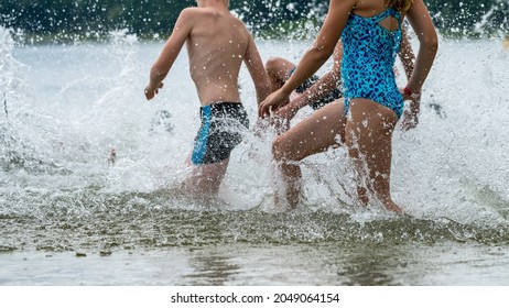 Children Running Into A Lake During A Kids Triathlon Competition