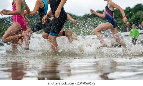 Children Running Into A Lake During A Kids Triathlon Competition