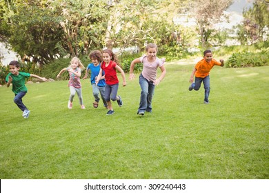 Children Running On The Grass In A Race