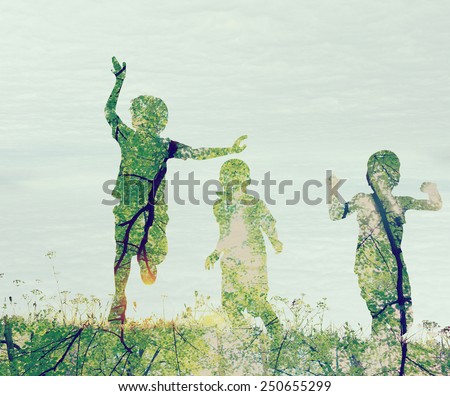 Children running on meadow at sunset double exposure