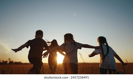 Children running in park at sunset. happy family kindergarten kids dream concept. Kids running in grass silhouette. Children playing outdoors lifestyle silhouette. Kids playing in park at sunrise - Powered by Shutterstock