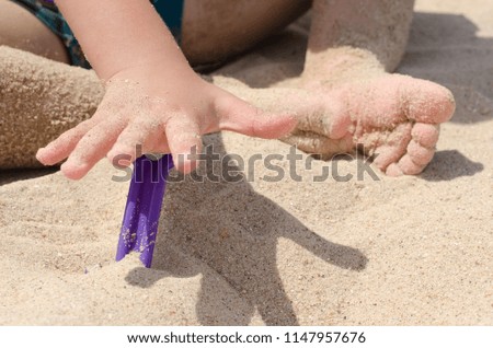 children in the sand at sea
