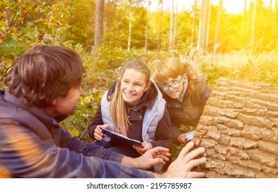 Children In A School Class Learn Tree Identification In The Forest At Förster In Summer