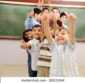 Children at school classroom with thumbs up