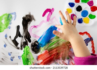 Children at school painting with finger paints. Lots of colors and lots of fun. Kid's hands stained with paint. - Shutterstock ID 2113539728