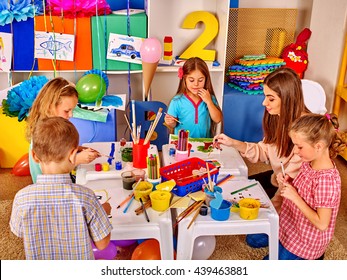 Children With School Teacher Woman Painting On Paper At Table In Primary Painting School .