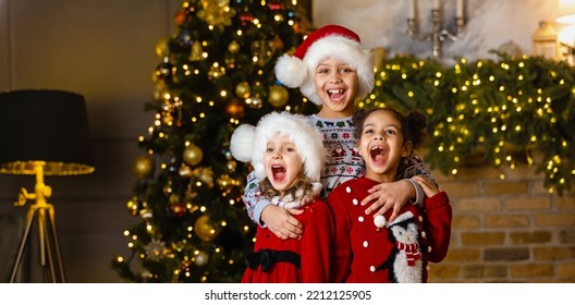 Children sing a song standing by the fireplace on Christmas Eve. - Powered by Shutterstock