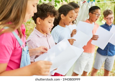 Children sing together in the choir at the summer camp on talent show
