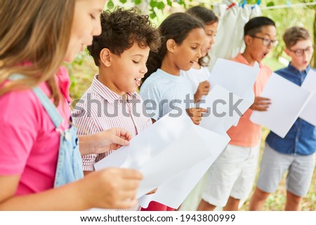 Children sing together in the choir at the summer camp on talent show
