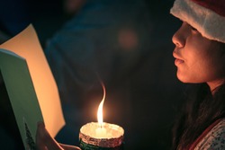 A Children Singer Of Caroler Hands Holding Candle And Book With Singing Carol Song On Celebration Of Christmas Day Background