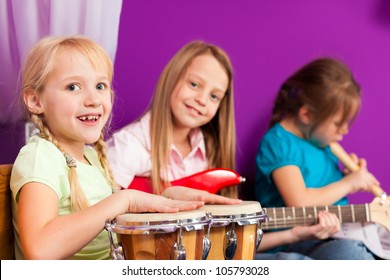 Children - Sisters - Making Music At Home, They Are Practicing Playing Guitar, Bongo And Flute As Instruments